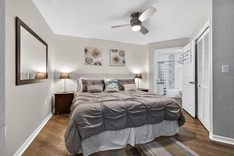 a bedroom with a bed and wooden floor