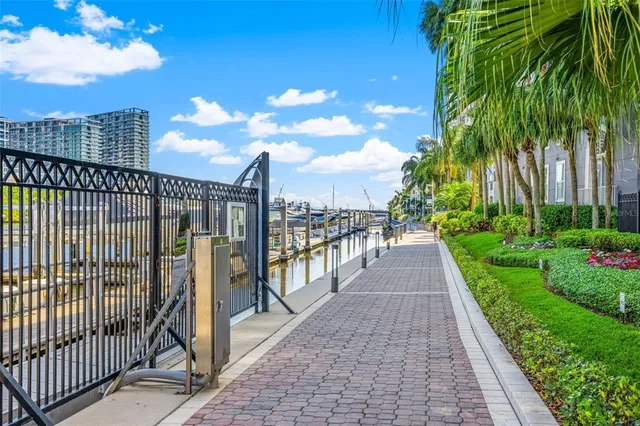 a view of a pathway with a wrought fence