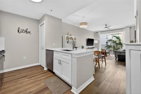 a view of kitchen with sink microwave and refrigerator