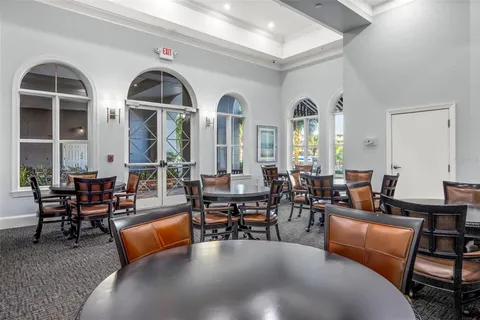 a living room with furniture pool view and large windows
