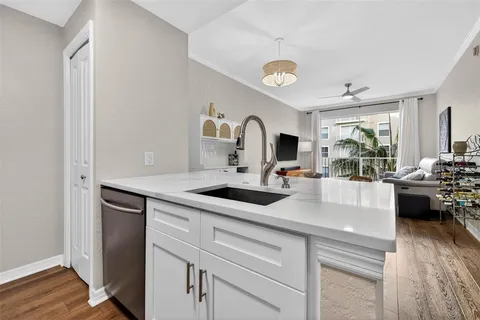 a kitchen with a sink and a stove top oven