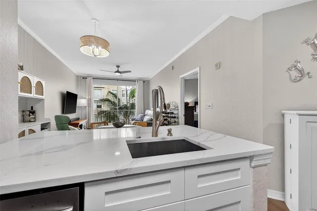 a view with granite countertop kitchen island a counter space a sink stainless steel appliances and cabinets