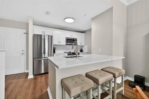 a kitchen with a sink cabinets and refrigerator
