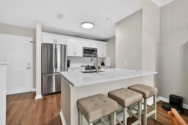a kitchen with a sink cabinets and refrigerator