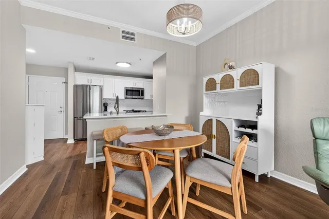 a dining room with furniture and wooden floor