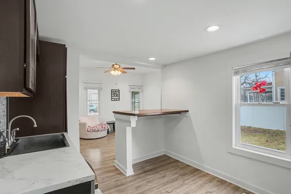 a hallway with a table and chairs