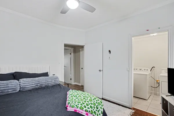 a bedroom with a bed and a chandelier