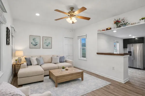 a living room with furniture and kitchen view