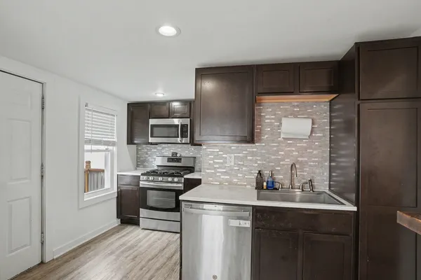 a kitchen with a sink appliances and cabinets