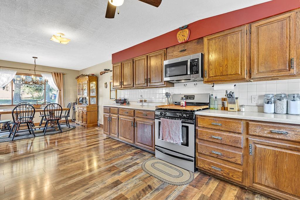 6437 Tuscarawas Road Midland, PA 15059 - Photo 11 of 29 a kitchen with stainless steel appliances granite countertop a stove and cabinets