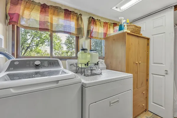 a view of bathroom with a sink and mirror