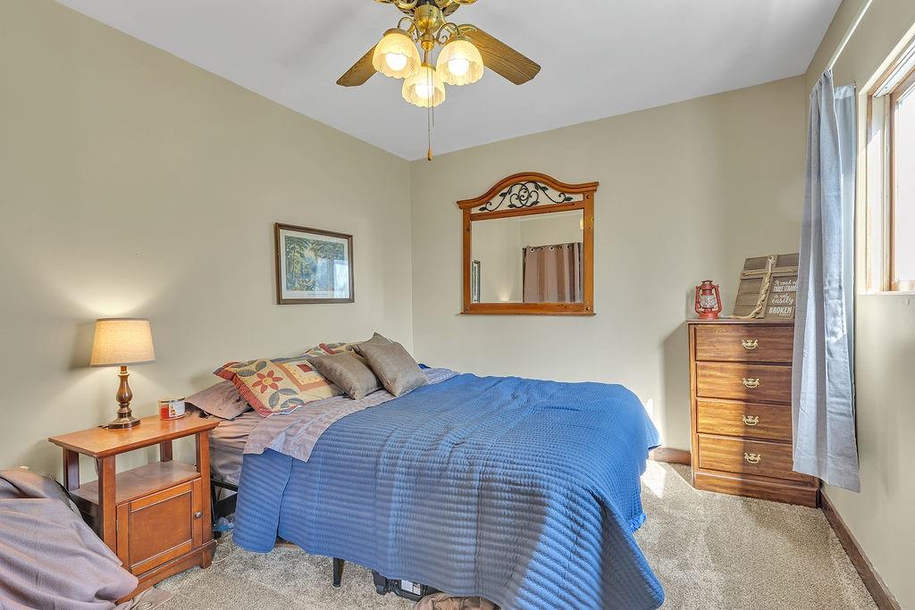6437 Tuscarawas Road Midland, PA 15059 - Photo 20 of 29 a bedroom with a bed and a chandelier