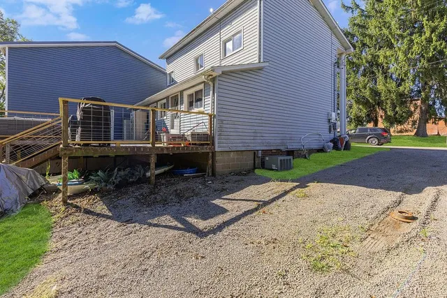 a view of house with deck and patio