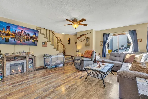 a living room with furniture and a fireplace