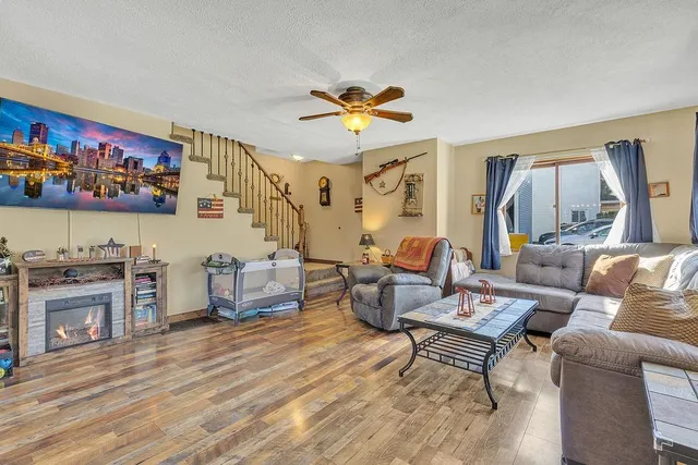 a living room with furniture and a fireplace