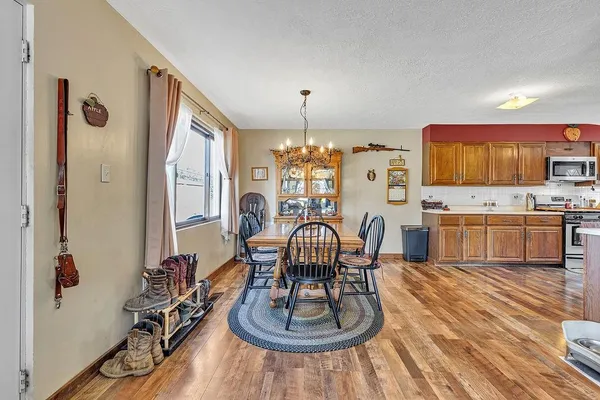 a dining room with furniture and wooden floor