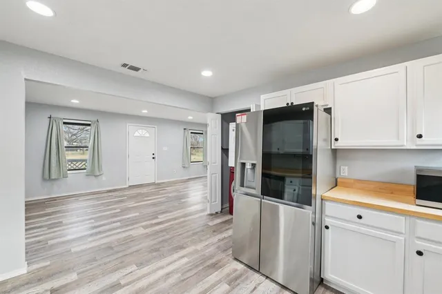 a kitchen with stainless steel appliances a refrigerator and a stove top oven