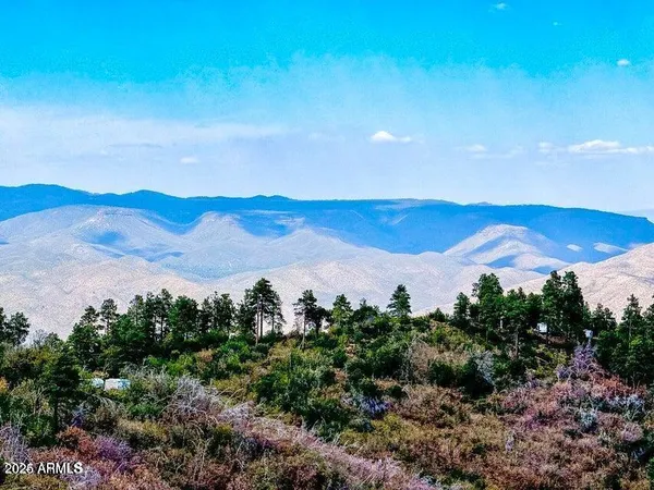 a view of mountain with sunset in background