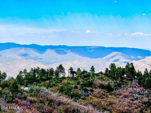a view of mountain with sunset in background