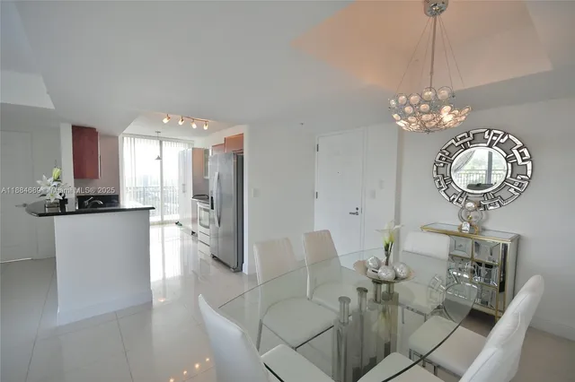 a view of a dining room with furniture and chandelier