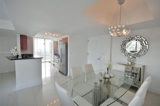 a view of a dining room with furniture and chandelier