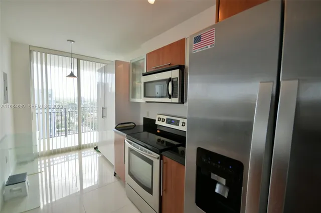 a kitchen with granite countertop a stove and a refrigerator