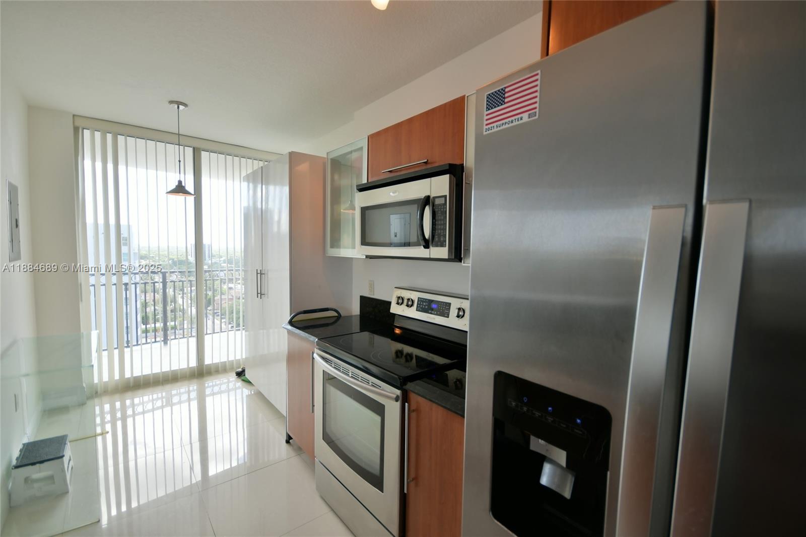 3232 Southwest 22nd Terrace, Unit 1502 Miami, FL 33145 - Photo 25 of 45 a kitchen with granite countertop a stove and a refrigerator