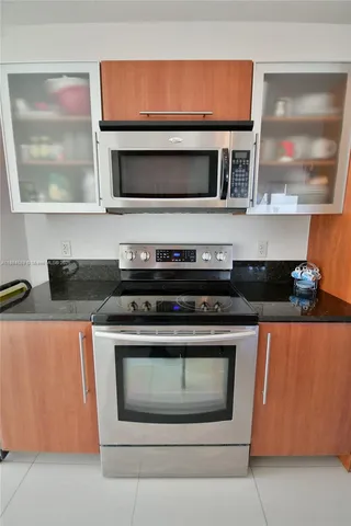 a stove top oven sitting inside of a kitchen
