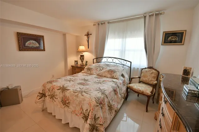 a bedroom with a bed and a view of kitchen