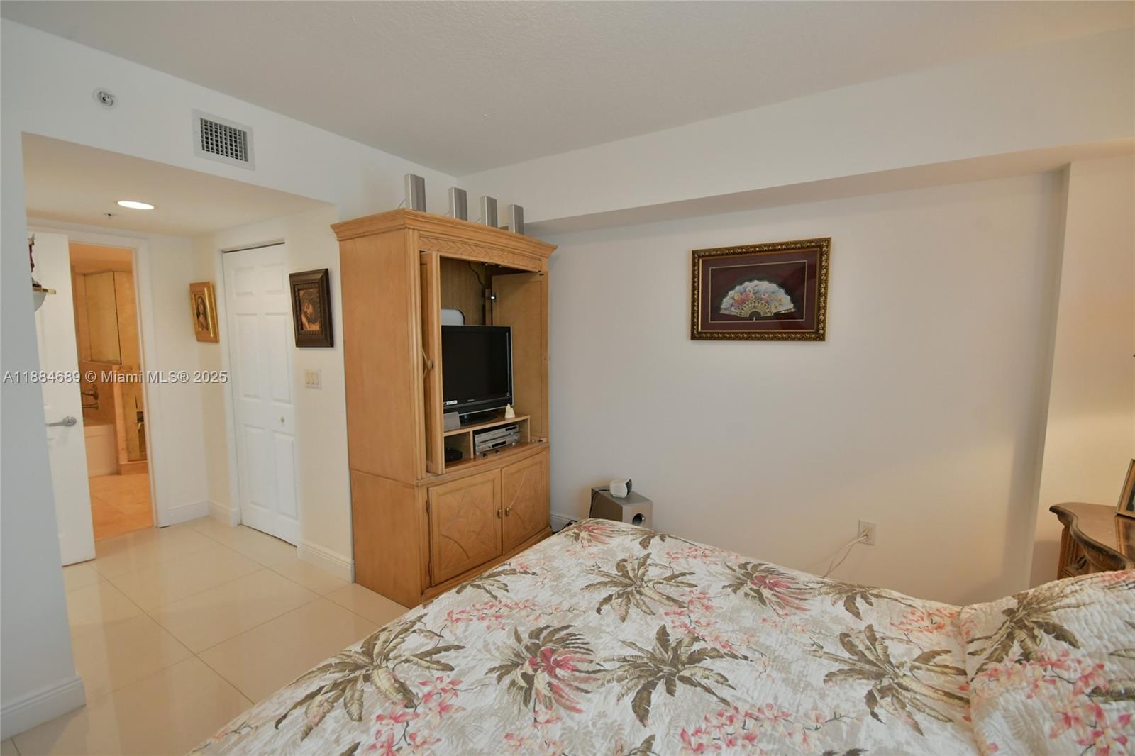3232 Southwest 22nd Terrace, Unit 1502 Miami, FL 33145 - Photo 30 of 45 a bedroom with a bed and a view of kitchen