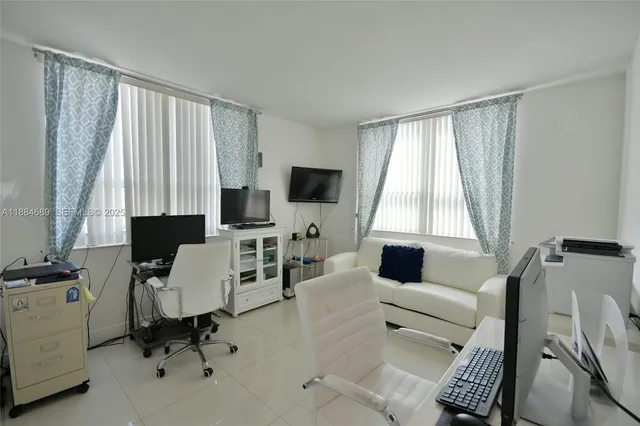 a view of a livingroom with furniture and a flat screen tv