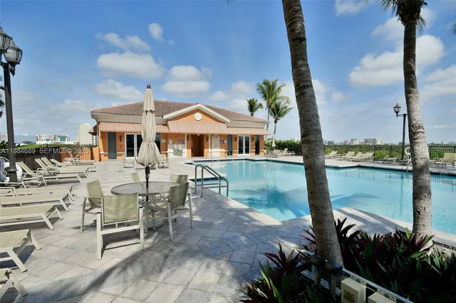 a view of a patio with swimming pool table and chairs