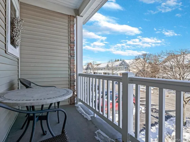 a view of a chairs and table in the balcony