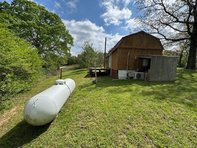0 Stones Road Camden, TN 38320 - Photo 16 of 28 a view of a backyard with table and chairs under an umbrella