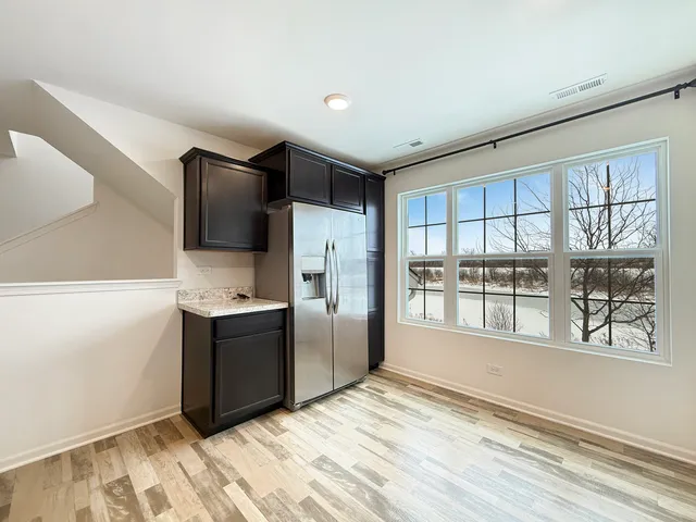 a kitchen with stainless steel appliances granite countertop a refrigerator and a stove top oven