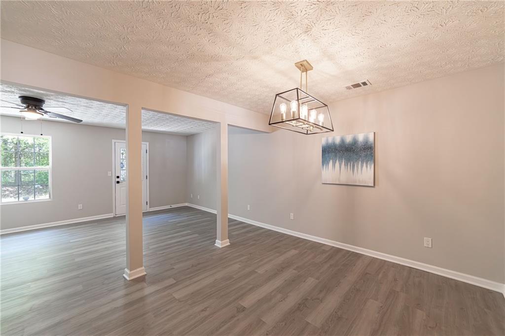 3017 Waldrop Circle Decatur, GA 30034 - Photo 13 of 52 an empty room with wooden floor fan and windows