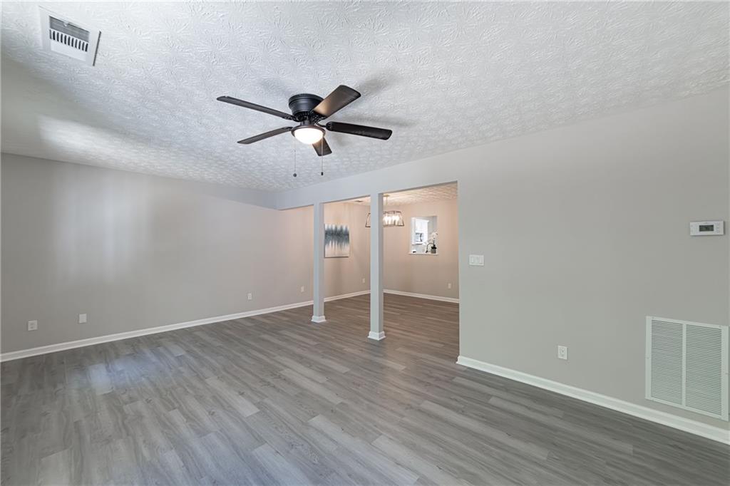 3017 Waldrop Circle Decatur, GA 30034 - Photo 16 of 52 an empty room with wooden floor and windows