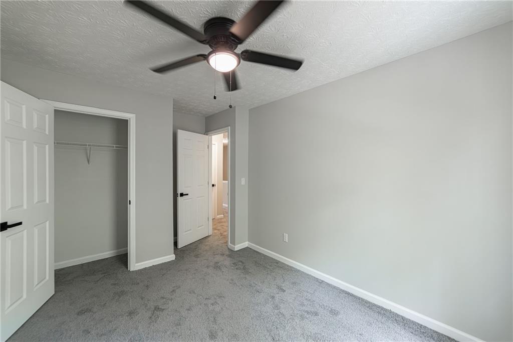 3017 Waldrop Circle Decatur, GA 30034 - Photo 43 of 52 an empty room with a chandelier fan and a ceiling fan