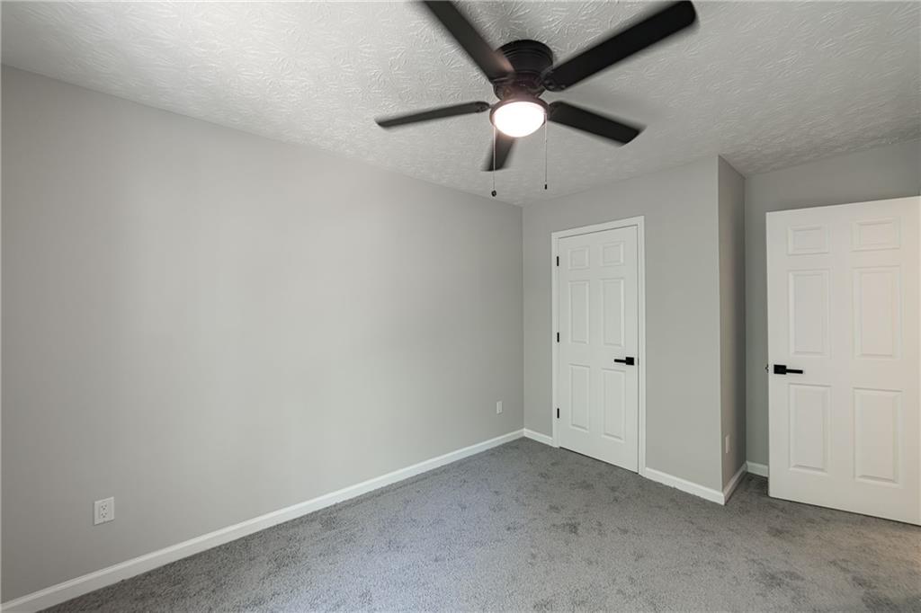 3017 Waldrop Circle Decatur, GA 30034 - Photo 44 of 52 an empty room with a ceiling fan and a window
