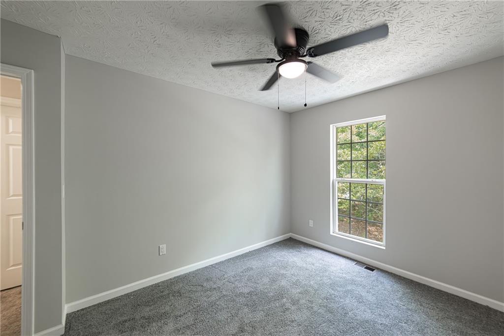 3017 Waldrop Circle Decatur, GA 30034 - Photo 45 of 52 an empty room with a window and a ceiling fan