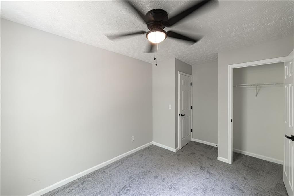 3017 Waldrop Circle Decatur, GA 30034 - Photo 47 of 52 an empty room with a ceiling fan and carpet