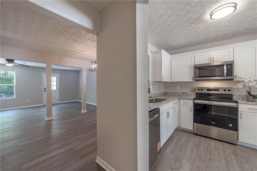 3017 Waldrop Circle Decatur, GA 30034 - Photo 7 of 52 a kitchen with stainless steel appliances a stove top oven a sink and a microwave