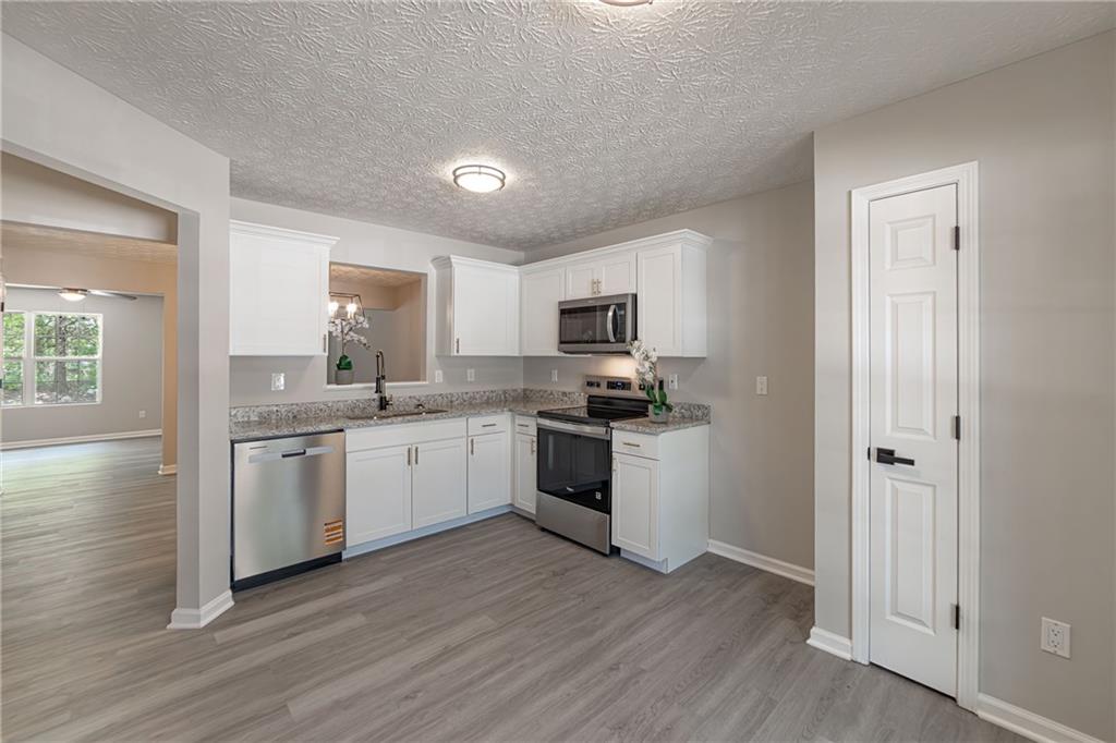 3017 Waldrop Circle Decatur, GA 30034 - Photo 8 of 52 a kitchen with a refrigerator stove top oven and sink