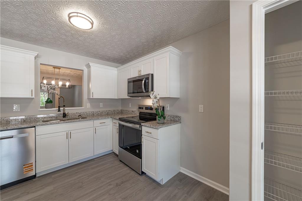 3017 Waldrop Circle Decatur, GA 30034 - Photo 9 of 52 a kitchen with stainless steel appliances granite countertop a sink and stove top oven