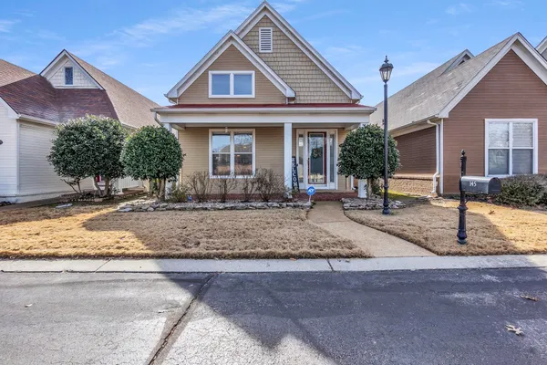 a front view of a house with porch and outdoor seating