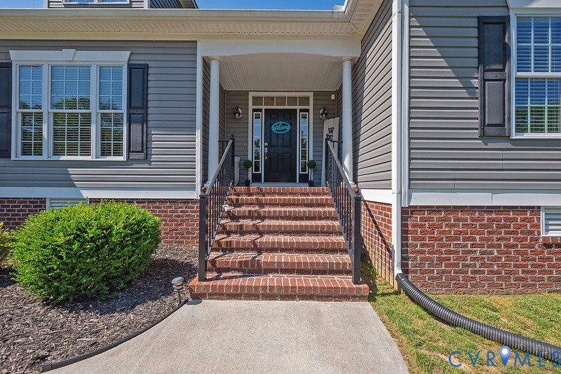 9425 Marie Road New Kent, VA 23124 - Photo 34 of 55 a front view of a house with a garden