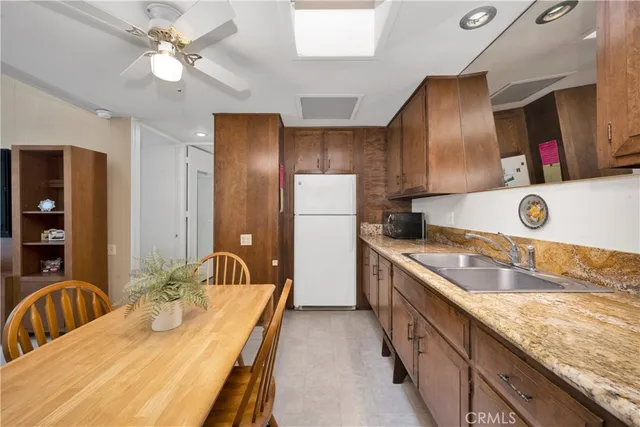 a bathroom with a granite countertop double vanity sink and mirror