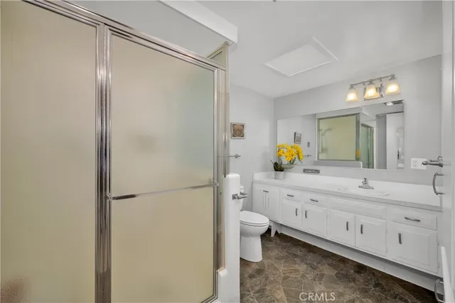 a spacious bathroom with a double vanity sink toilet and shower