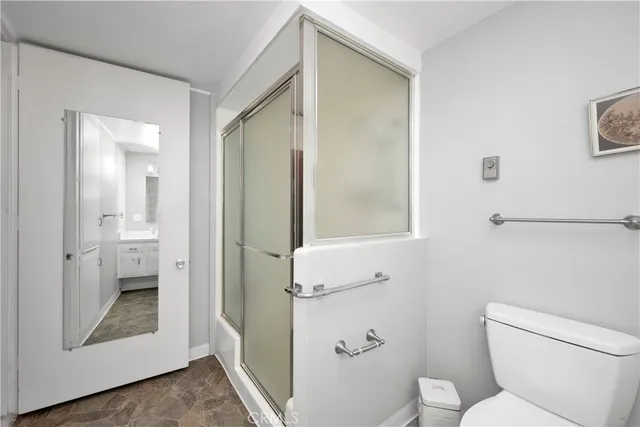 a bathroom with a toilet and a shower