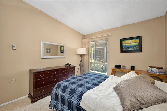 a bedroom with a bed and a dresser with a bookshelf